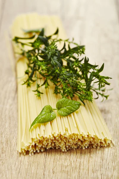 Italian pasta on wooden background — Stock Photo, Image