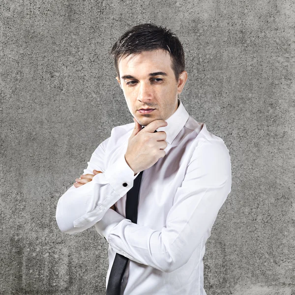 Confused businessman on grunge background — Stock Photo, Image