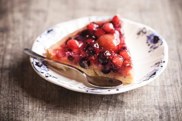 Delicious fruit tart dessert on wooden background