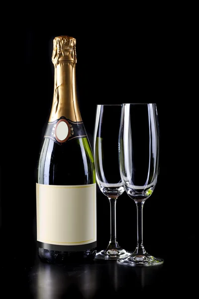 Champagne bottle and two glasses on black background — Stock Photo, Image