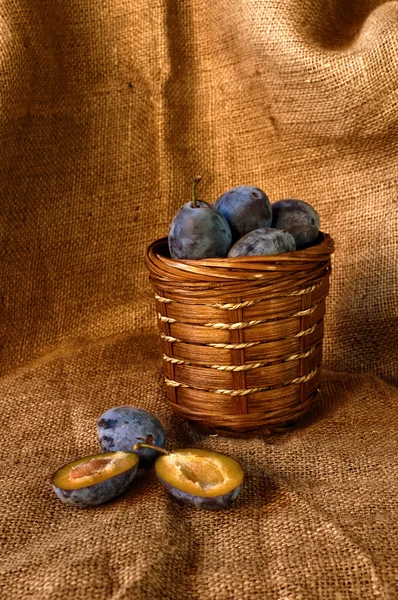 Plum on table and a punnet — Stock Photo, Image