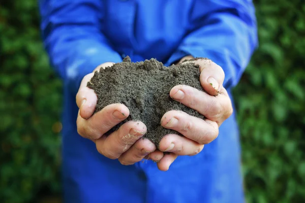 A talaj mezőgazdasági munkavállaló kezében — Stock Fotó