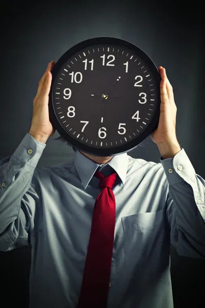 Businessman with black clock, deadline concept — Stock Photo, Image