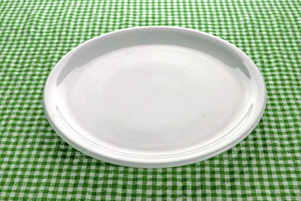 Empty plate on kitchen table