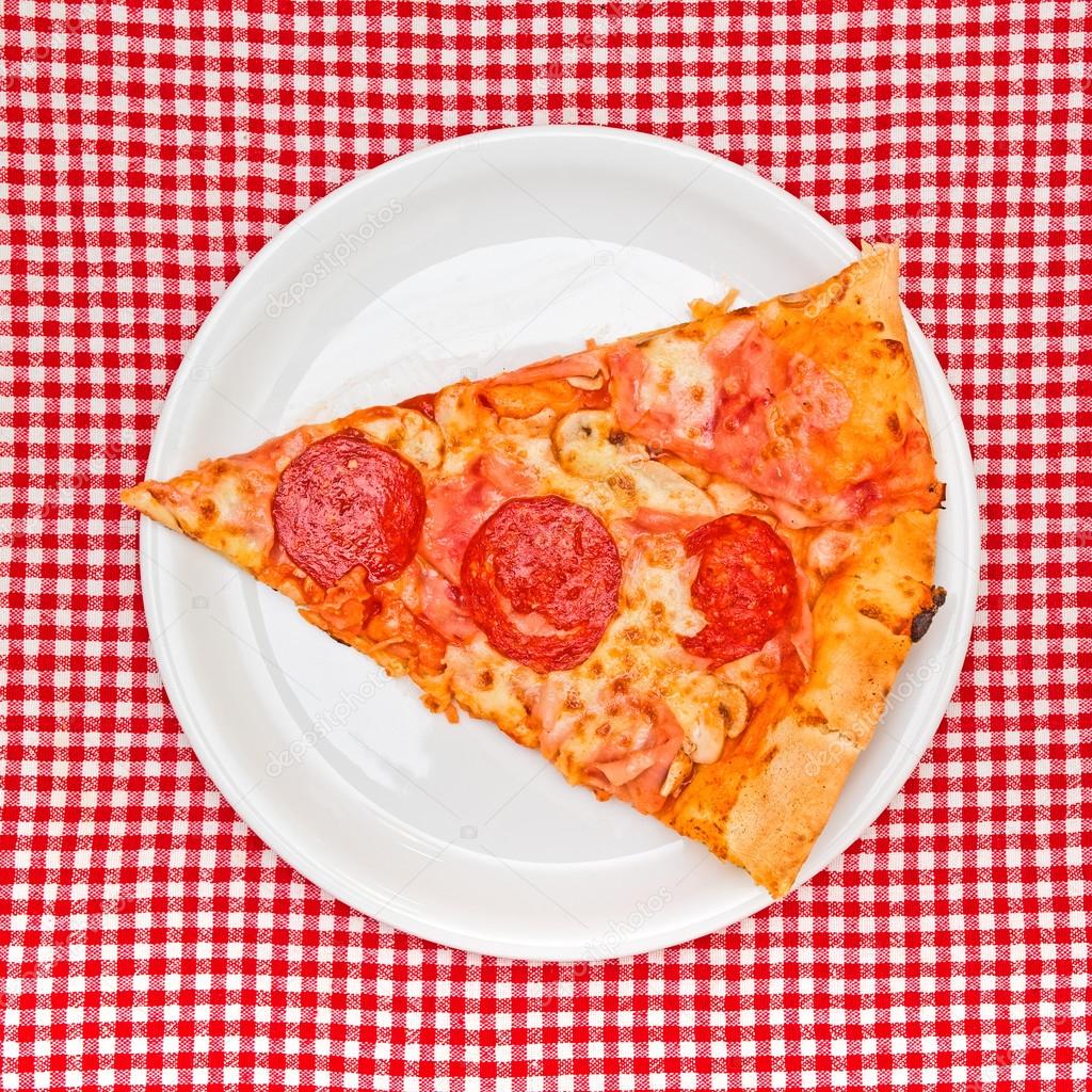 Pepperoni pizza slice on white plate