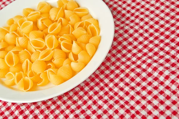 Raw pasta on plate — Stock Photo, Image