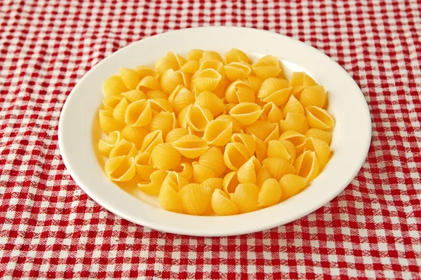 Raw pasta on plate — Stock Photo, Image