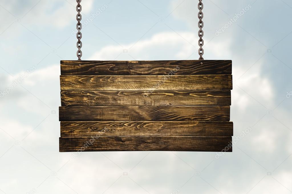 Wooden signpost hanging on chains