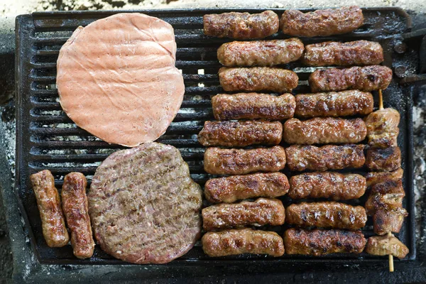 Grilled meat on the barbeque plate — Stock Photo, Image