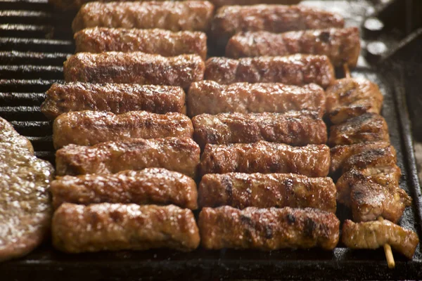 Grilled meat on the barbeque plate — Stock Photo, Image