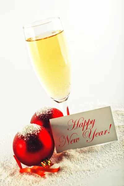 Happy New Year. White wine and christmas balls with greeting car — Stock Photo, Image