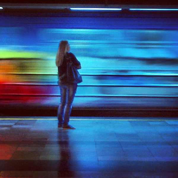 People on platform of Belgrade subway station Vukov spomenik looking at fast moving train passing by them. — Stock Photo, Image