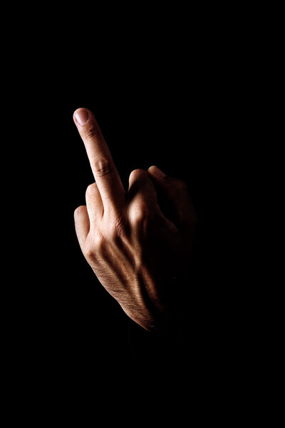 Middle finger on black background