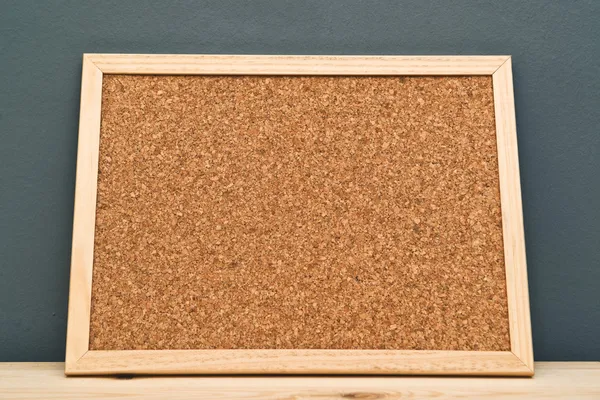 Cork memory board on wooden cabinet — Stock Photo, Image