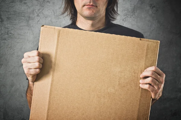 Man holding cardboard paper — Stock Photo, Image