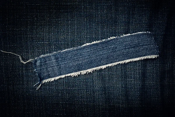Textura de jeans azul rasgado — Fotografia de Stock