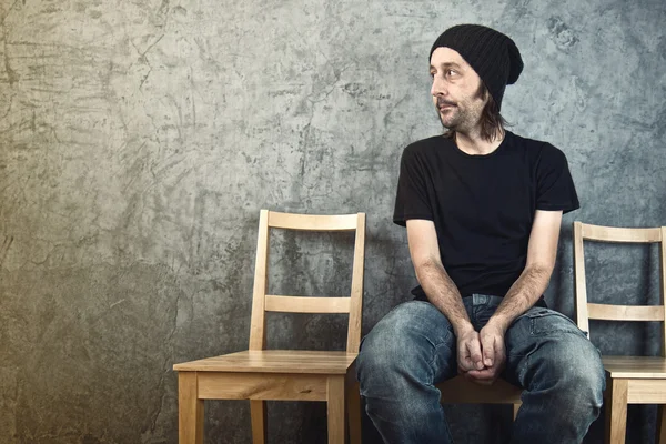 Man sitting on wooden chair and waiting — Stock Photo, Image