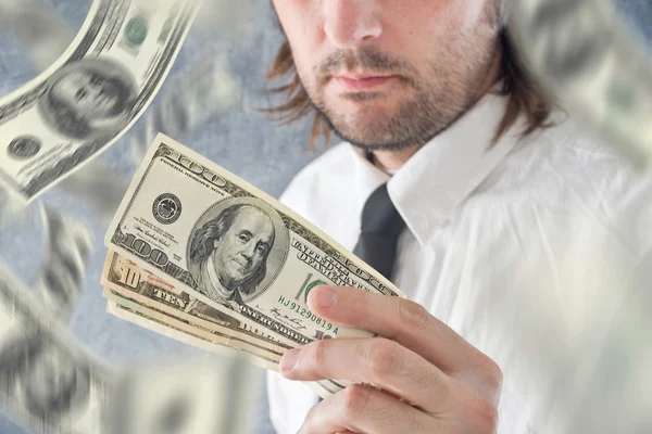 Businessman holding US dollars, bnknotes falling from the sky — Stock Photo, Image