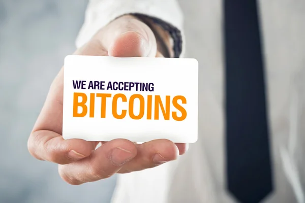 Businessman holding card with title WE ARE ACCEPTING BITCOINS — Stock Photo, Image