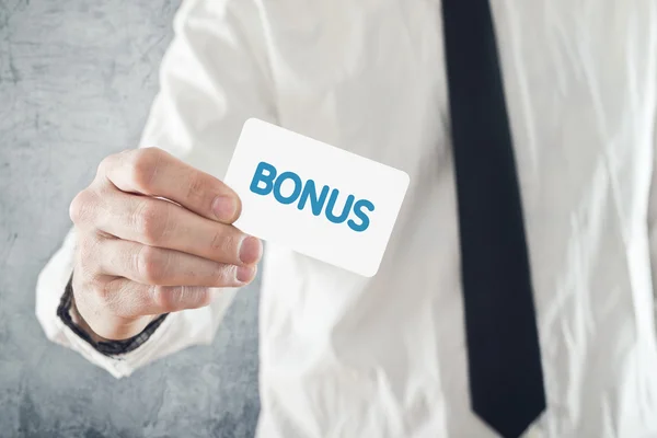 Businessman holding Bonus card. — Stock Photo, Image