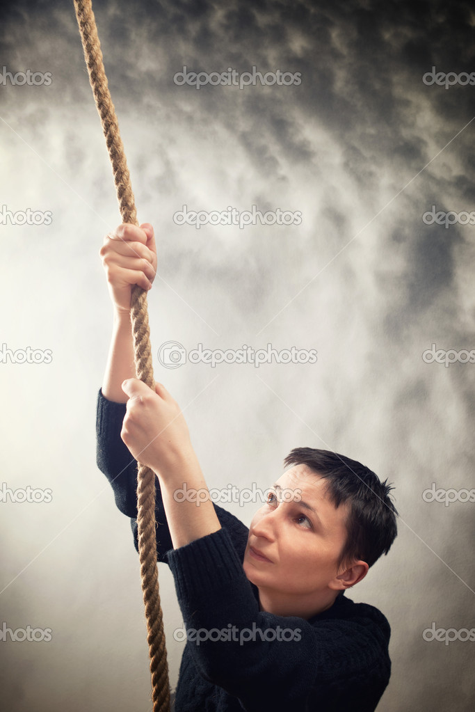 Woman climbing up with rope