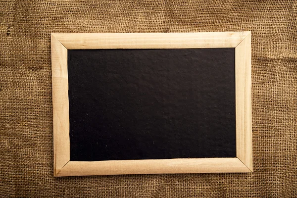 Empty blackboard on jute canvas — Stock Photo, Image