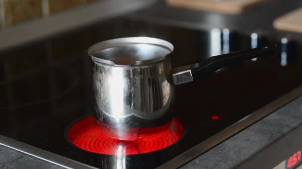 Coffee pot on cooking plate with boiling water in. — Stock Video