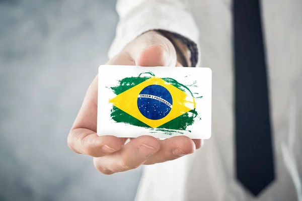 Brazilian Businessman holding business card with Brazil Flag — Stock Photo, Image