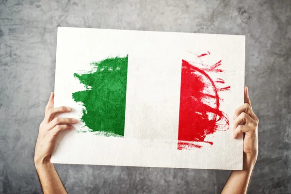 Italy flag. Man holding banner with Italian Flag.