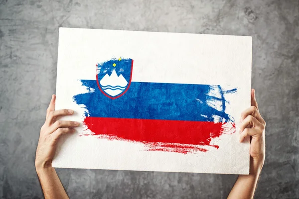 Slovenia flag. Man holding banner with Slovenian Flag. — Stock Photo, Image