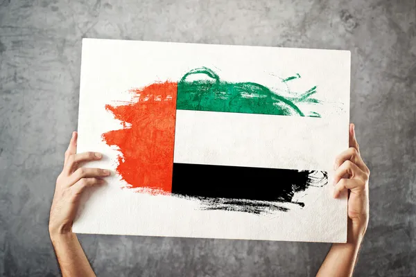 United Arab Emirates flag. Man holding banner with UAE Flag. — Stock Photo, Image