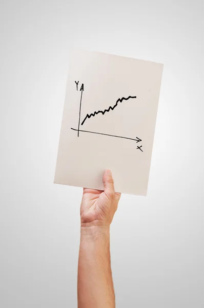 Hombre sosteniendo papel con dibujo de diagrama — Foto de Stock