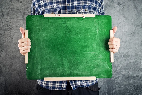 Man holding green chalkboard — Stock Photo, Image