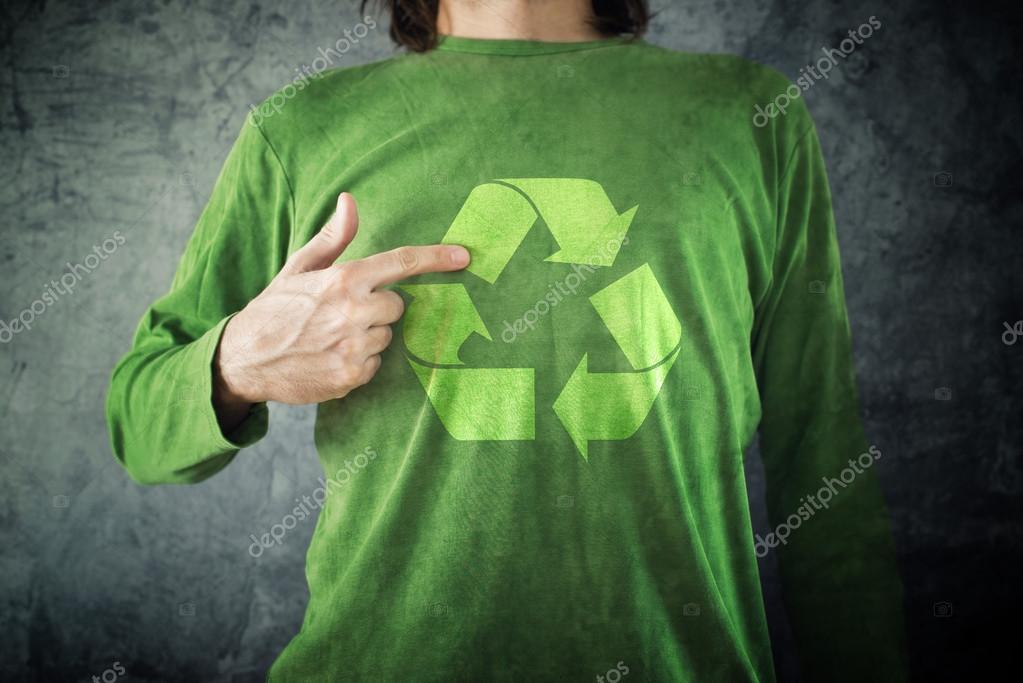 RECYCLE. Man pointing to recycling symbol printed on his shirt Stock