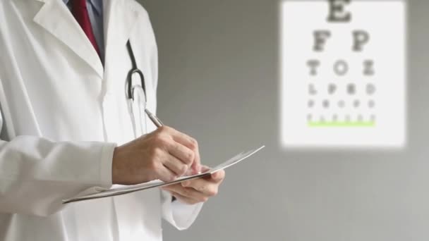 Male ophthalmologist doctor writing prescription to patient after eye examination. — Stock Video