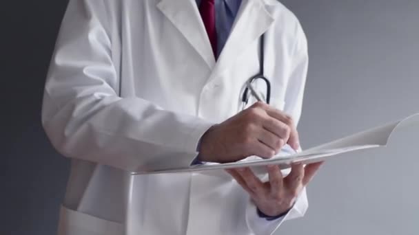 Male doctor is writing RX prescription while standing. Health care professional writing. — Stock Video