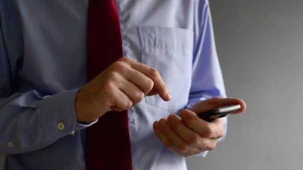 Empresário gravando mensagem de texto em seu smartphone. Usando a tecnologia moderna para a comunicação e organização de tarefas de negócios . — Vídeo de Stock