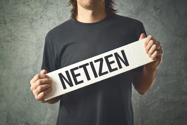 Man holding white banner with word NETIZEN printed — Stock Photo, Image