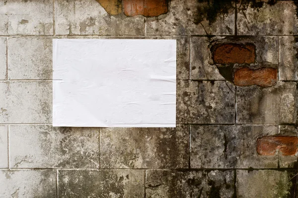 Blank white poster on grunge wall — Stock Photo, Image