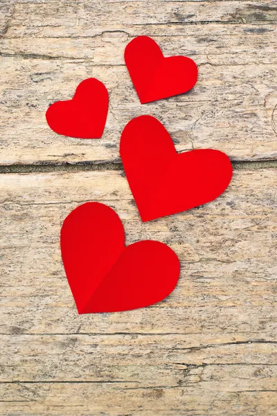 Red paper hearts on grunge wooden background — Stock Photo, Image