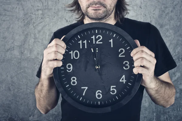 Man holding big black clock — Stock Photo, Image