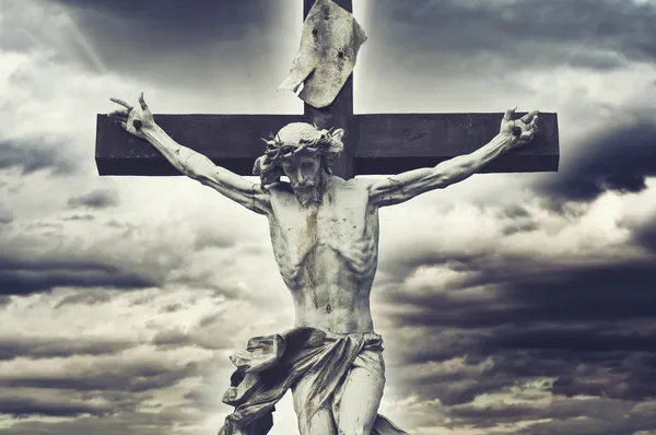 Crucifixion. Christian cross with Jesus Christ statue over storm — Stock Photo, Image