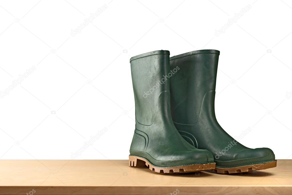 Green rubber boots on white background