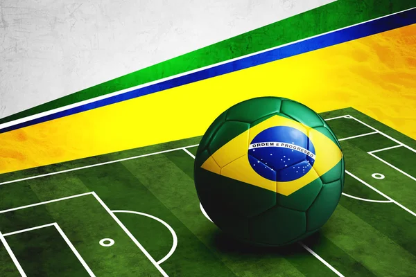 Soccer ball with Brazil flag on pitch — Stock Photo, Image