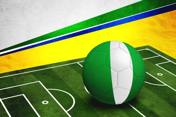 Soccer ball with Nigeria flag on pitch — Stock Photo, Image