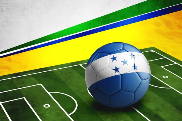 Soccer ball with Honduras flag on pitch — Stock Photo, Image