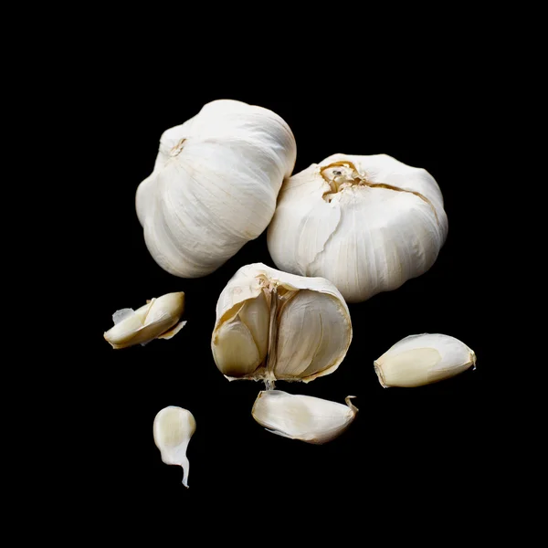 Garlic bulbs on black background — Stock Photo, Image