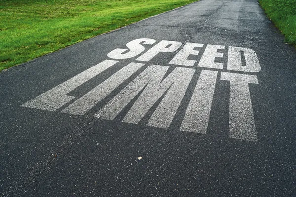 Speed Limit message reminder on asphalt road — Stock Photo, Image