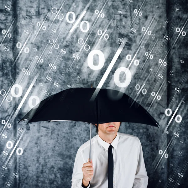 Businessman with umbrella protecting himself from percentage rai — Stock Photo, Image