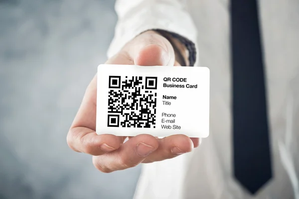 Businessman holding QR code business card — Stock Photo, Image